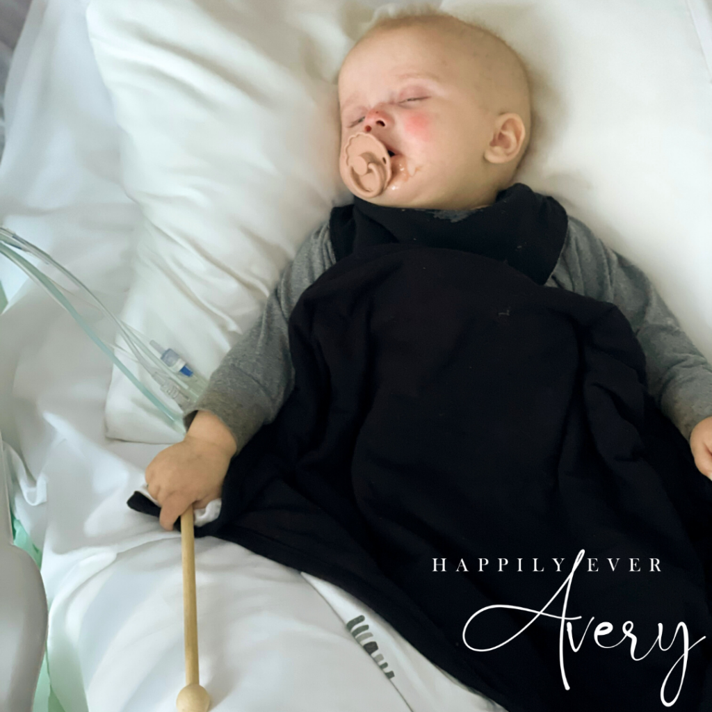 baby with cancer sleeping holding xylophone stick