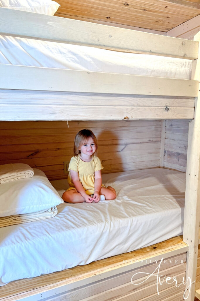 big sis is excited about her bunk beds at jellystone park